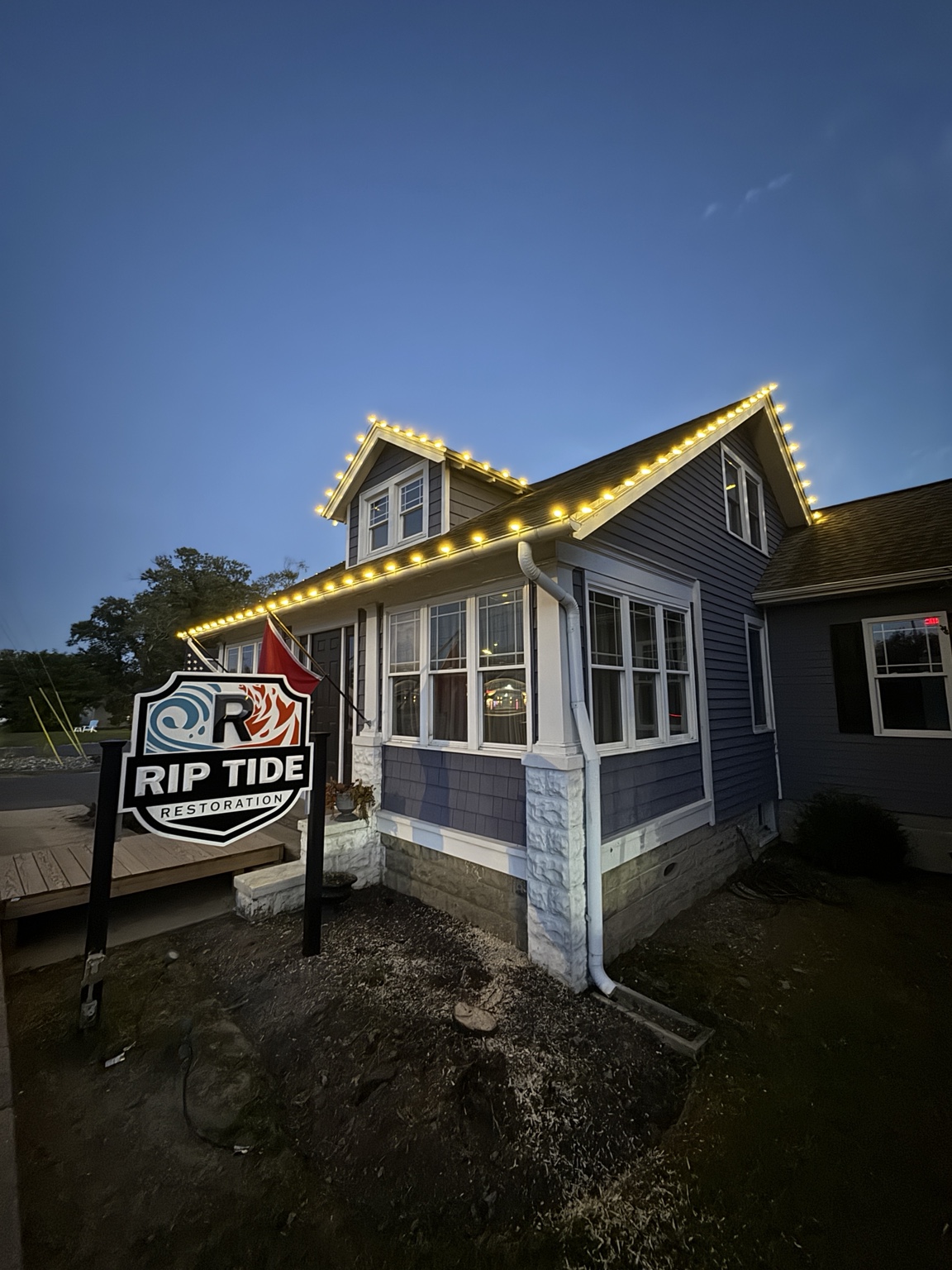 Warm white roofline lights on the Rip Tide Restoration office