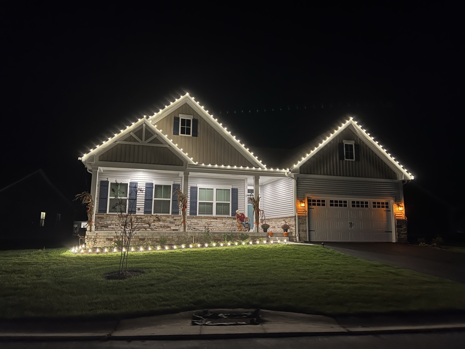 Professionally installed warm white holiday lights outlining a home
